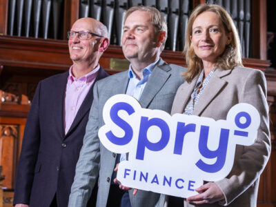 Spry Finance sponsorship of The Guinness Choir - holding logo in front of organ