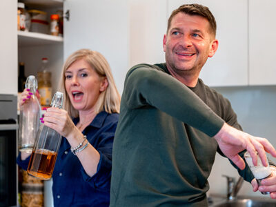 Couple in their fifties making dinner, availing of the mortgage for homeowners over 55 with Spry Fiinance