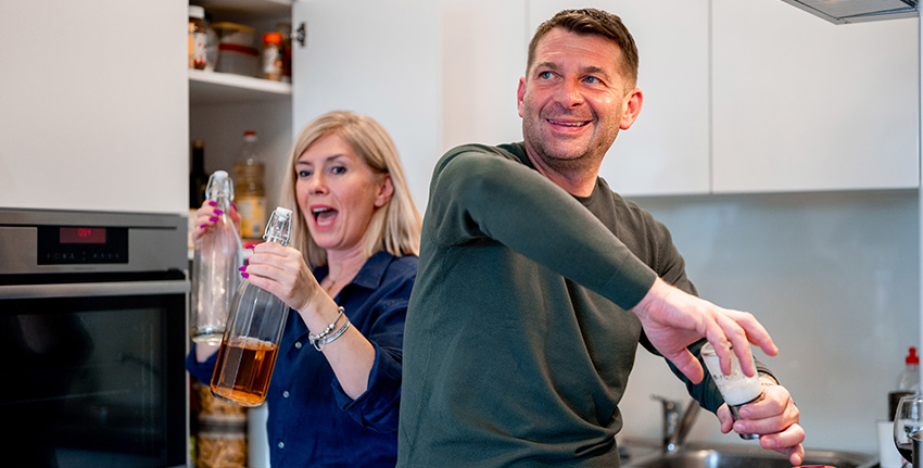 Couple in their fifties making dinner, availing of the mortgage for homeowners over 55 with Spry Fiinance